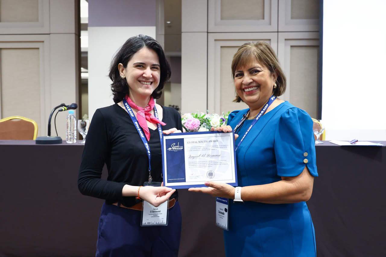 Zaynab El Bernoussi receives her award certificate from Irasema Coronado.